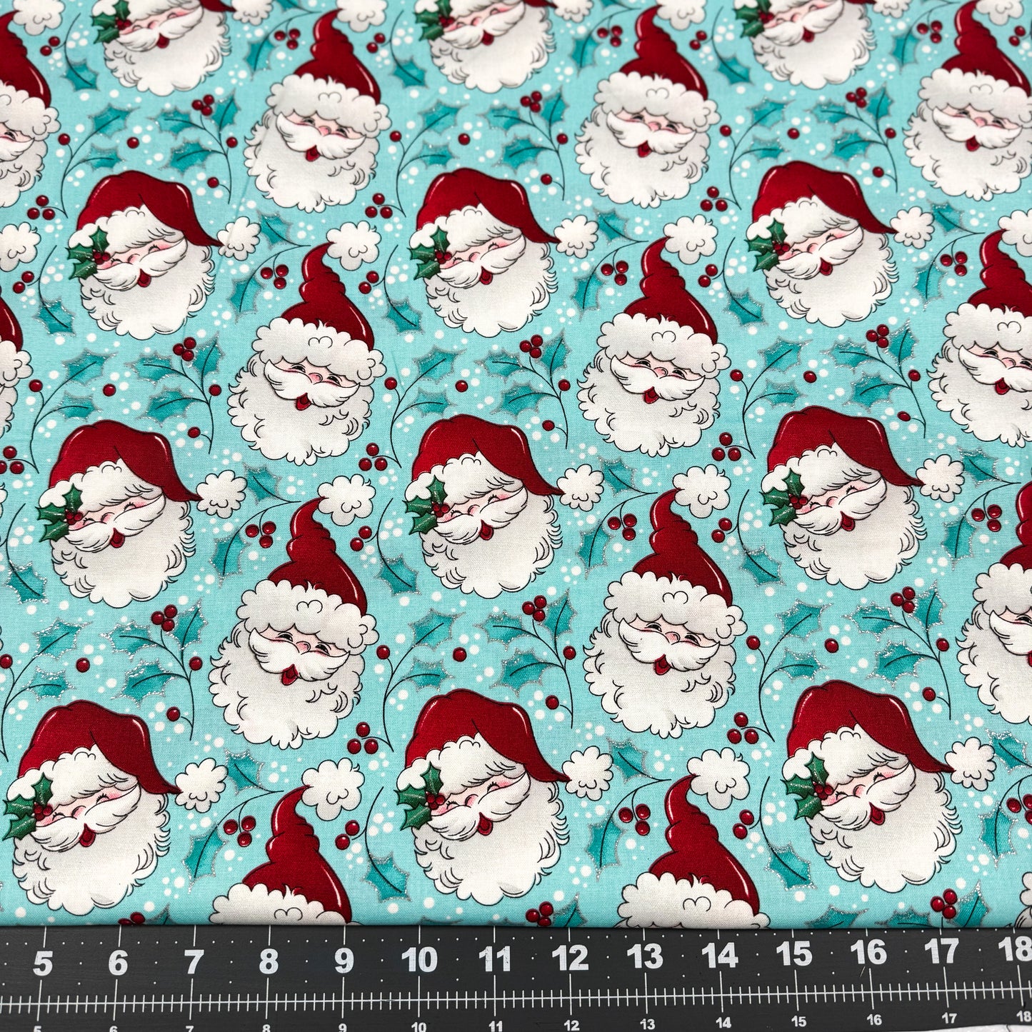 Tossed Santa faces w Glitter Christmas fabric
