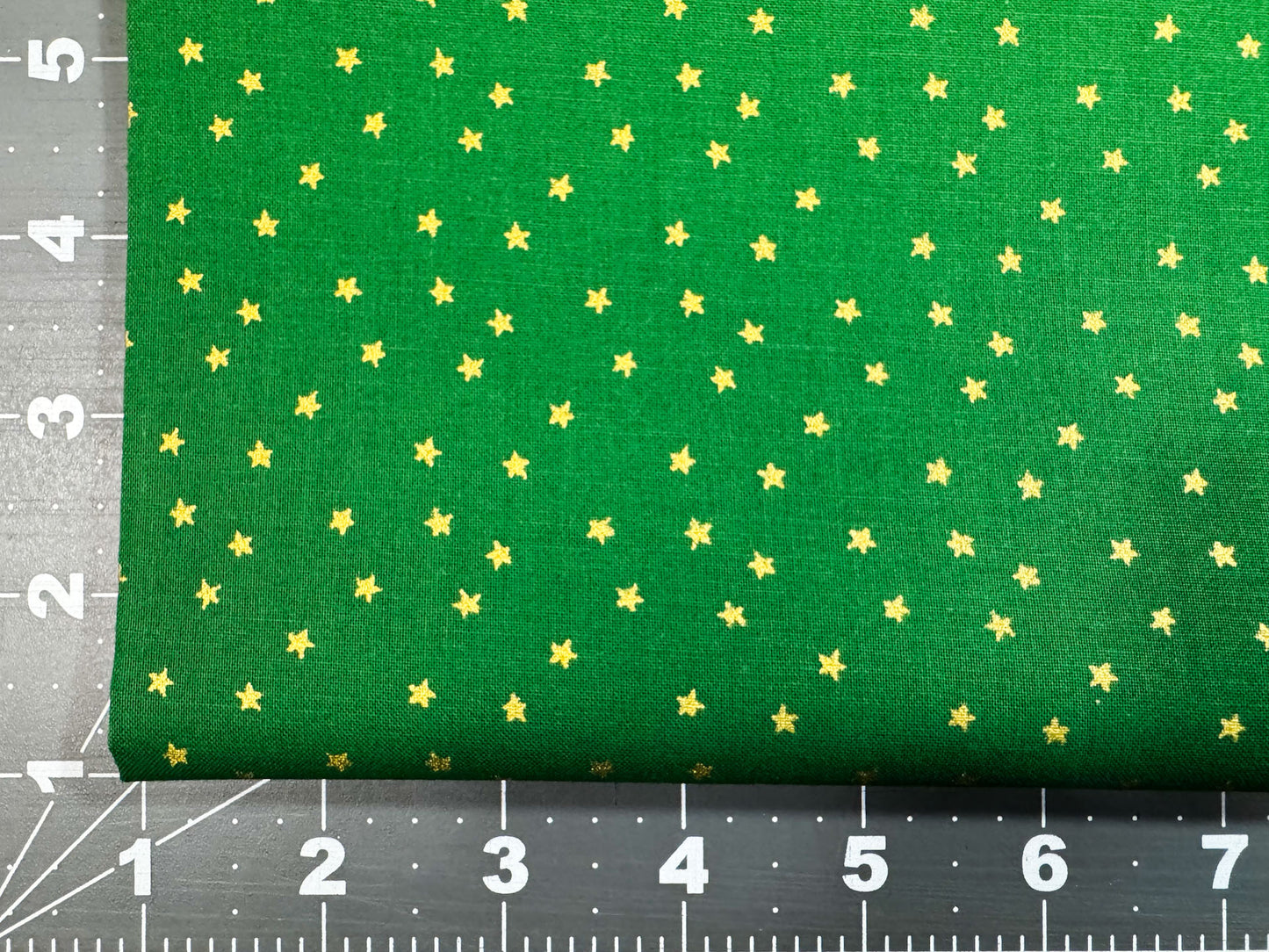 Mini Metallic Gold Star on Green fabric
