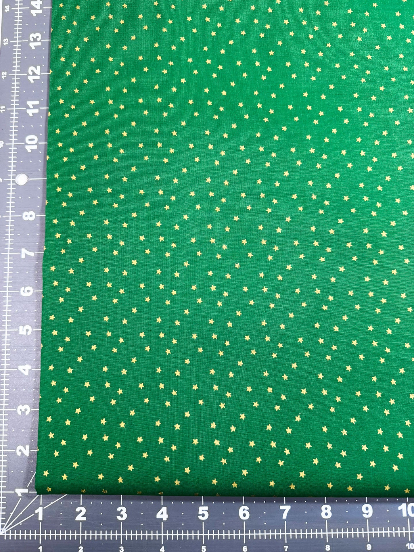 Mini Metallic Gold Star on Green fabric