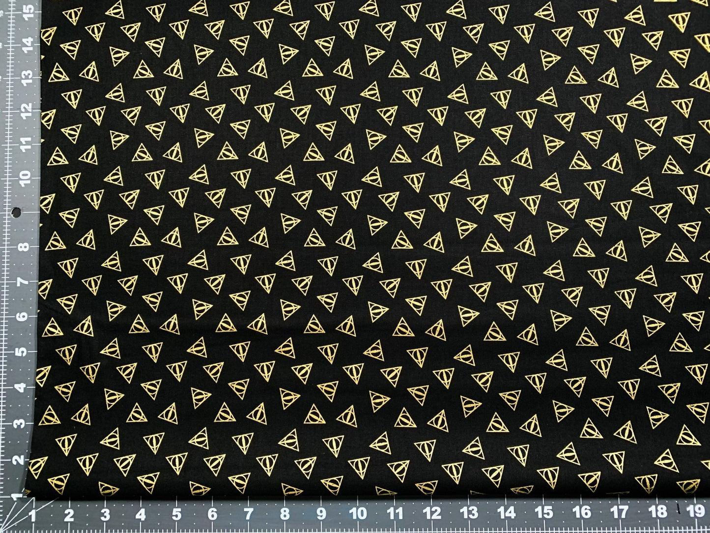 Harry Potter fabric Gold Metallic Deathly Hallows Logo - Mary Jo Fabrics