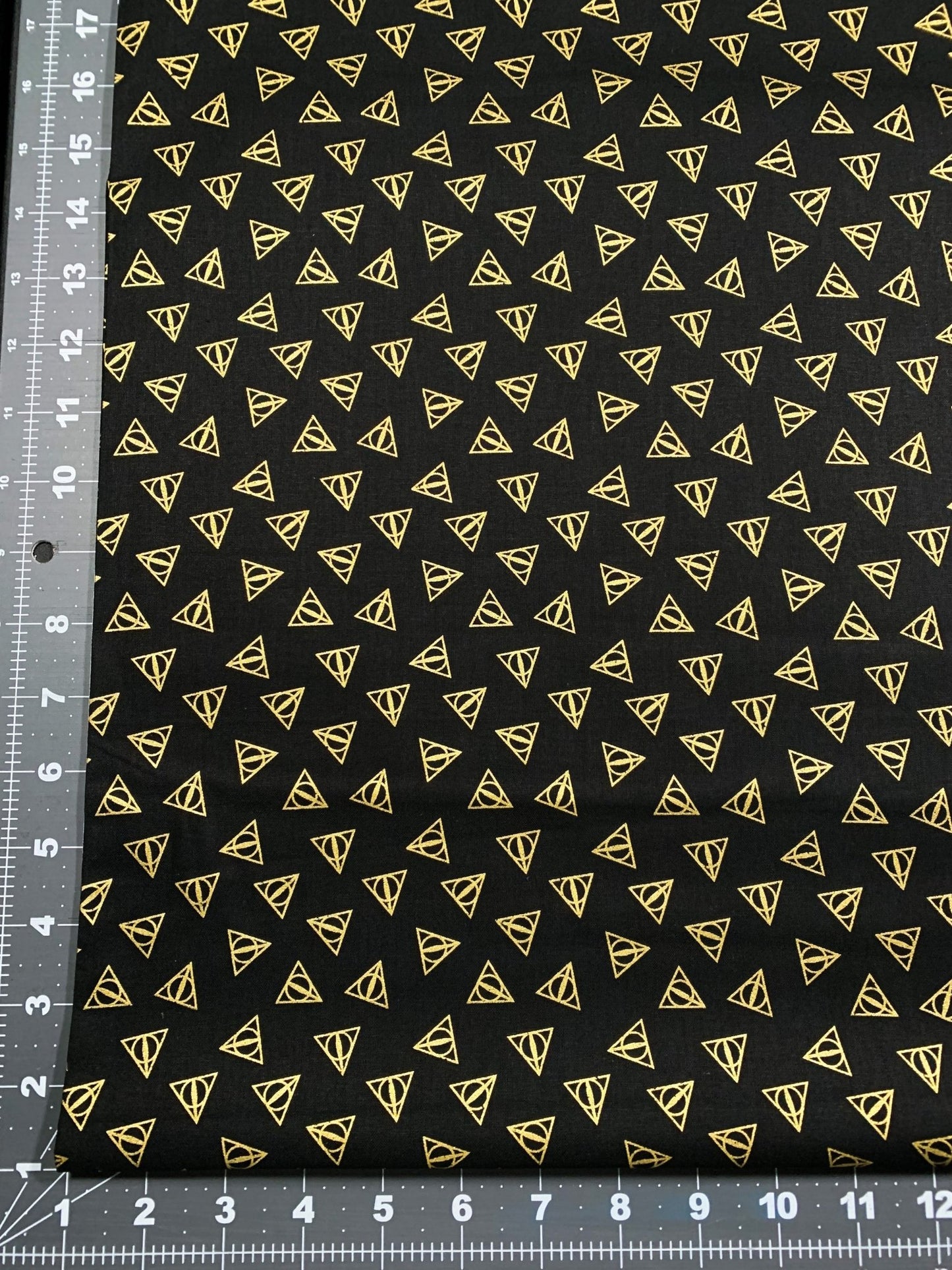 Harry Potter fabric Gold Metallic Deathly Hallows Logo - Mary Jo Fabrics