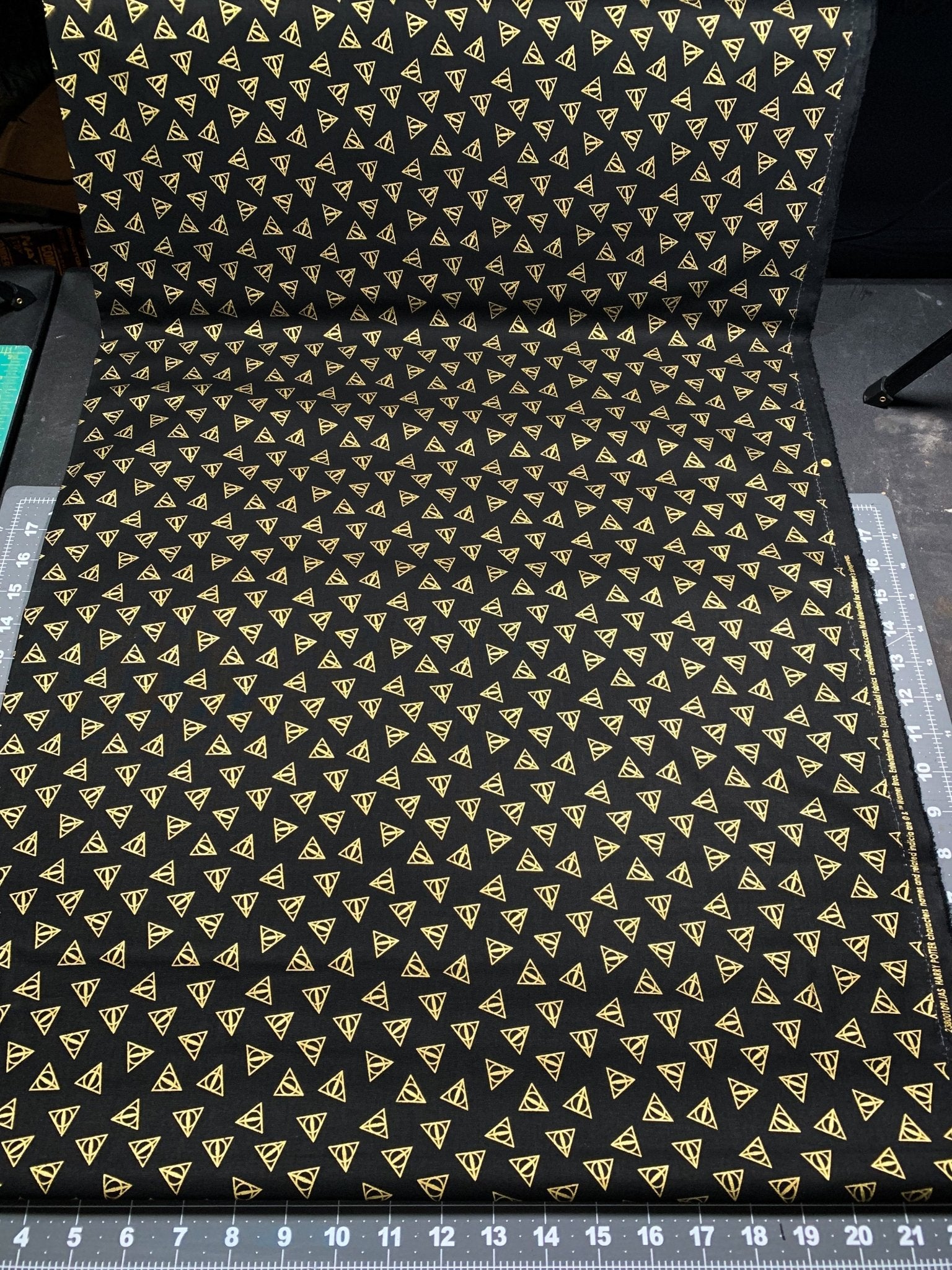 Harry Potter fabric Gold Metallic Deathly Hallows Logo - Mary Jo Fabrics