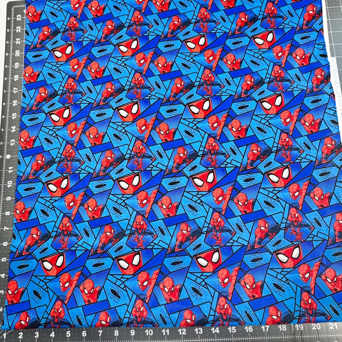 Marvel Spiderman Fabric on Blue with Black Spiders - Mary Jo Fabrics