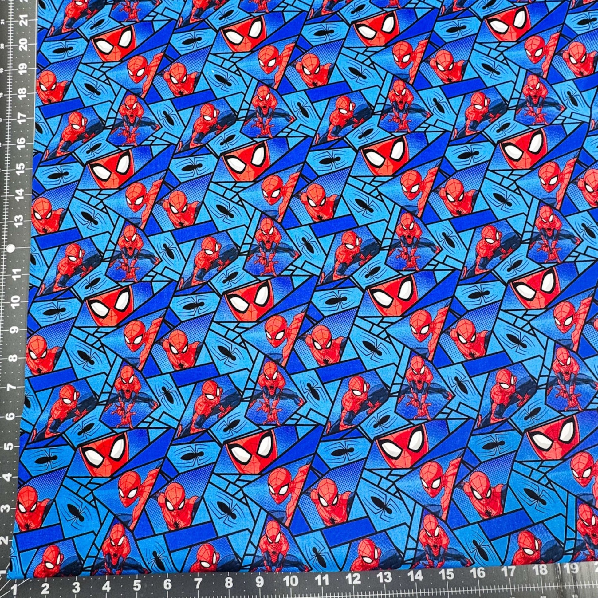 Marvel Spiderman Fabric on Blue with Black Spiders - Mary Jo Fabrics