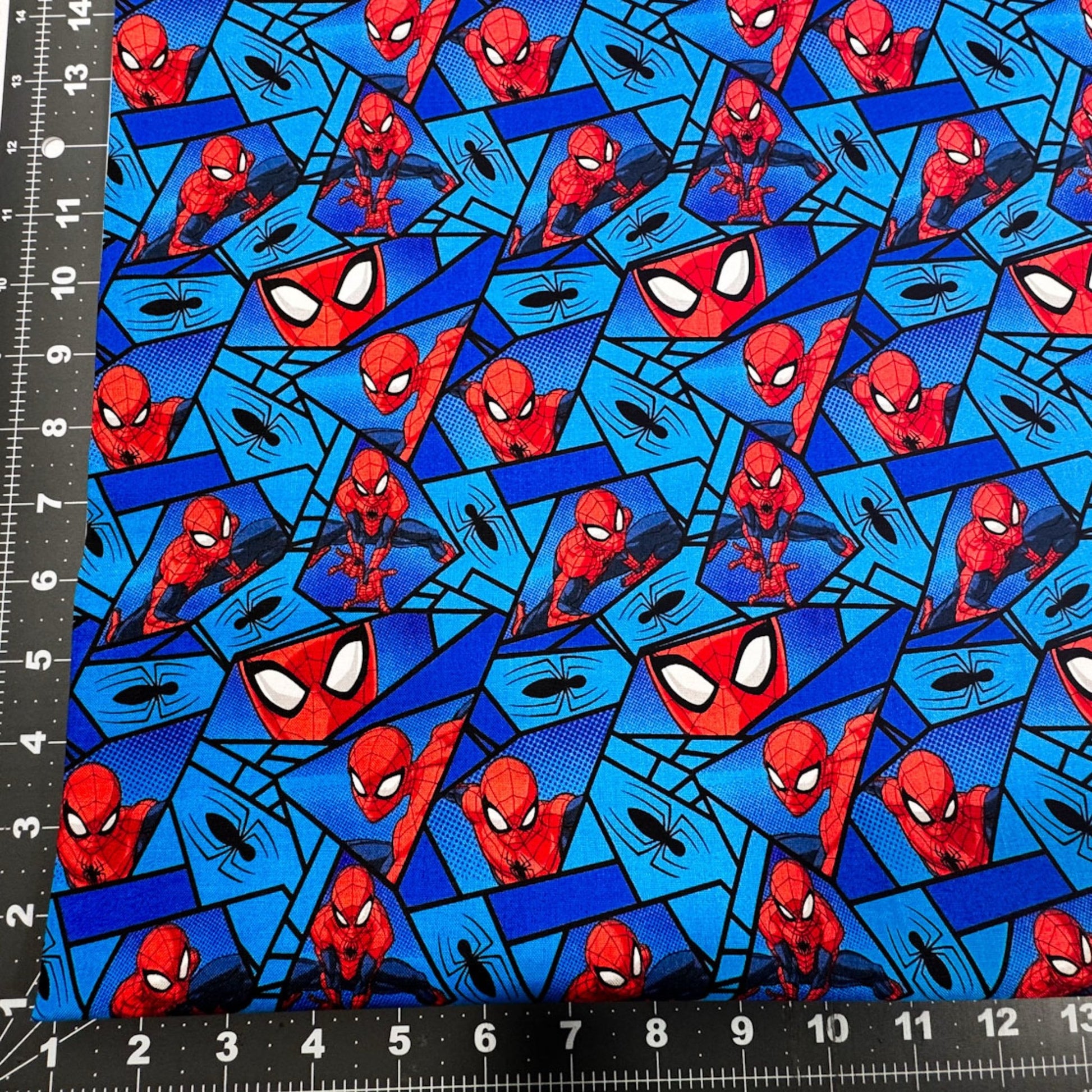 Marvel Spiderman Fabric on Blue with Black Spiders - Mary Jo Fabrics